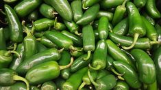 many green peppers are piled up together