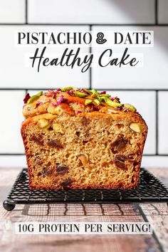 a close up of a piece of cake on a rack with the words pistachio and date healthy cake