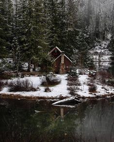 a small cabin in the middle of a snowy forest