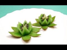 two slices of kiwi sitting on top of a white plate next to each other