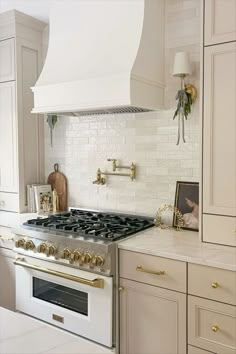 a white stove top oven sitting inside of a kitchen next to cabinets and counter tops