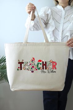 Christmas Teacher Bag, Personalized Christmas Gift Tote Bag, Christmas Bag, Shoulder Bag For Teacher, Custom Teacher Tote Bag HOW TO ORDER: 1. Please, Check and Review all Photos.  2. Select Your Bag Style and Color from the drop-down menu 3. Choose Your Quantity as much as you want. 4. Click "Add To Cart". For multiple items go back to the listing and repeat the steps. *DETAILS OF THE BAGS: 25L Tote Bag Measurements - 20"L x 15"H x 5"D 100% cotton , 25" self-fabric handles , 11" handle drop Large main compartment with zippered closure Inside zippered flap pouch pocket * PROCESSING & SHIPPING: Processing time is 1-2 days. First Class Shipping is 2-5 business days (after processing time). You can upgrade your shipping on the check out page to UPS Ground and UPS-2 Day Business Services (afte Red Christmas Gift Bags, Christmas Tote Bag As Gift, Christmas Gift Tote Bag, Christmas Tote Bag Gift, Christmas Rectangular Bag, Christmas Teacher Gifts, Christmas Gift For Teacher, Teacher Custom, Teacher Tote Bag