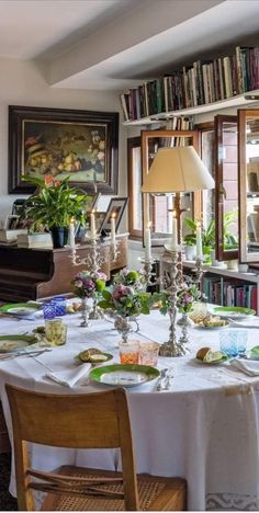 a dining room table is set with plates and glasses