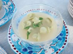 a bowl filled with soup on top of a blue and white plate