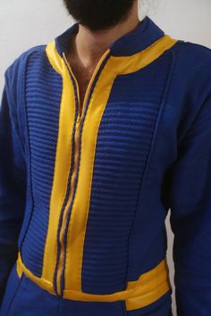 a man with a beard wearing a blue and yellow outfit