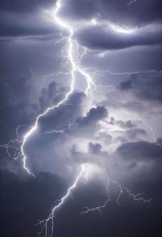 a lightning bolt hitting through the dark clouds