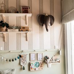 the wall is decorated with elephant heads and other things on it's shelfs