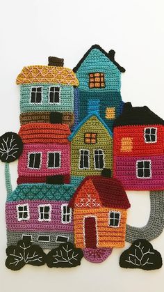 a group of crocheted houses sitting next to each other