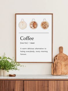 a coffee poster hanging on the wall next to a cutting board and potted plant