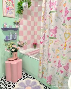 a bathroom decorated in pastel pink and green