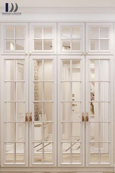 an empty room with white walls and glass doors