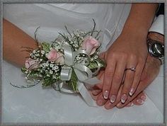 the bride and groom are holding hands with their wedding rings on their fingernails