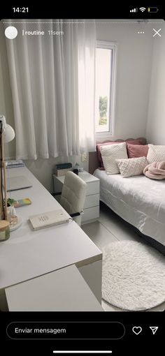 a white bed sitting next to a window in a bedroom