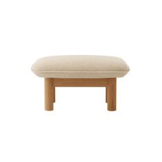 the foot stool is made out of wood and has a beige upholstered cushion