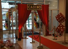 a casino themed event with red curtains and gold roped off signs on the front door