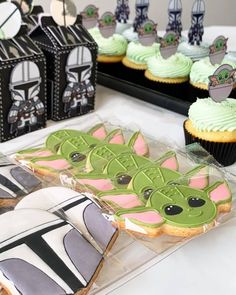 star wars themed cookies and cupcakes are on display