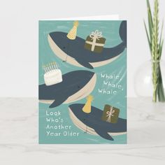 a birthday card with two whales holding presents