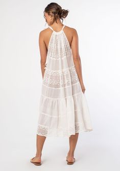 An elegant bohemian swim cover-up dress. Designed in sheer cotton gauze with mixed lace panels. Swim cover-up Mixed media Relaxed, flowy fit Sleeveless Mid-length Tiered body Drawstring halter neckline Tie shoulder Sheer Bohemian cotton midi dress Elevate your beach wardrobe with this ultra-pretty swim cover-up. A dreamy midi dress style featuring an adjustable drawstring halter neckline, a flattering flowy sheer silhouette, and a tiered body for extra shape and movement. Model is 5'9, wearing a Sheer Midi Dress, Beach Wardrobe, Womens Boho Dresses, Swim Cover Up Dress, White Bohemian, Elegant Bohemian, Midi Dress Style, Cotton Midi Dress, Boho Dresses