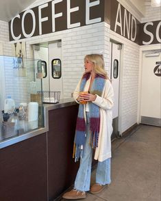 a woman standing in front of a coffee shop