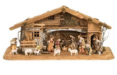 a nativity scene with figurines and animals in front of a wooden structure