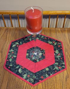 This is a hexagon shaped wintertime Christmas table topper that measures 18 by 16 inches. It is made of two fabrics.  One is a glittered holly berries and leaves which I added a an edging around the topper with red Christmas crackle fabric. The reverse side is white with a middle layer of cotton batting. Christmas Crackle, Christmas Table Topper, Red Crackle, Christmas Table Toppers, Holly Berries, Table Topper, Hexagon Shape, Table Toppers, Centerpiece Decorations