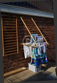 clothes drying outside in front of a brick building