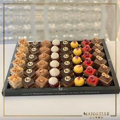 a chocolate chess board with different types of desserts on it's sides and in the middle