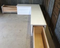 two white tables with drawers on each side