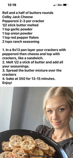 a woman holding a plate with cookies on it and the recipe in front of her