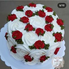 a cake with white and red roses on it