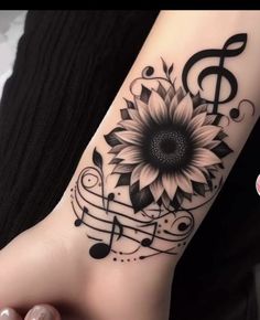 a woman's foot with music notes and a sunflower on it