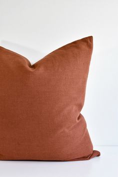 a brown pillow sitting on top of a white table