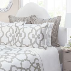 a bed with blue and white comforters in a bedroom