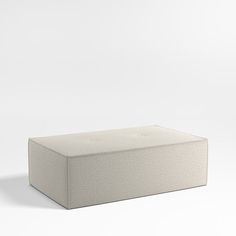 a white box sitting on top of a white floor next to a black object in the background