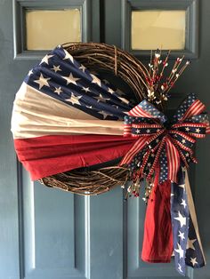 an american flag wreath hanging on the front door