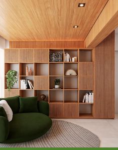 a green chair sitting in front of a bookshelf