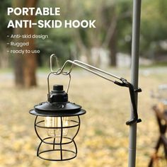 an outdoor lamp with the words portable anti - skid hook attached to it in front of a park bench