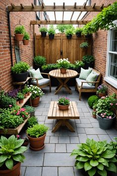 an outdoor patio with potted plants and wooden benches in the center, surrounded by brick walls