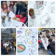 children are sitting at tables with drawings on them