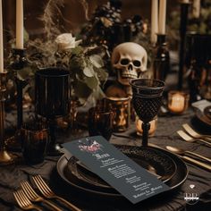 a table set with candles, plates and menu cards for halloween dinner or wedding reception