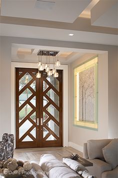 a living room filled with furniture and a wooden door