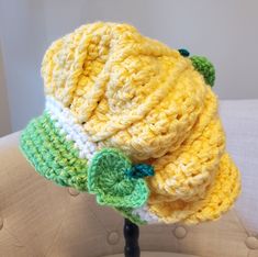 a crocheted hat is sitting on a stand