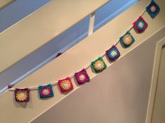 there are crocheted squares hanging from the ceiling