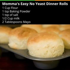 some bread rolls are on a metal tray and there is information about the different types