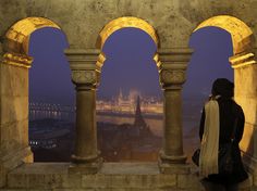 a woman looking out over the city at night