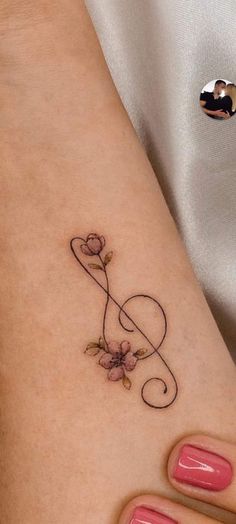 a woman's foot with a tattoo on it and a flower in the middle