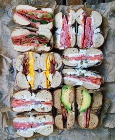 a bunch of sandwiches sitting on top of each other next to each other with different toppings