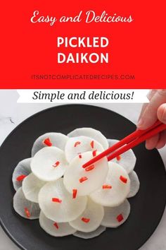 pickled daikon on a black plate with red chopsticks and text overlay that reads easy and delicious pickled daikon