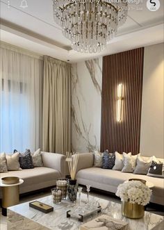 a living room filled with furniture and a chandelier