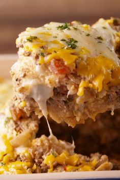 a close up of a casserole dish with meat and cheese